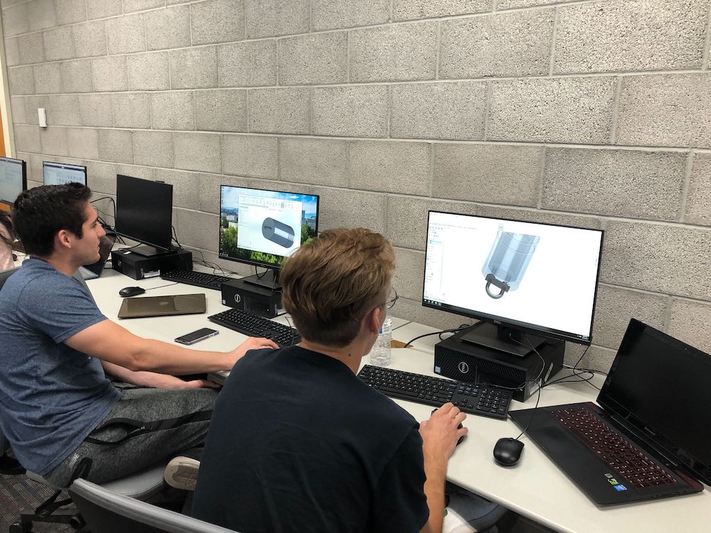 Members designing level 1 rockets in solidworks